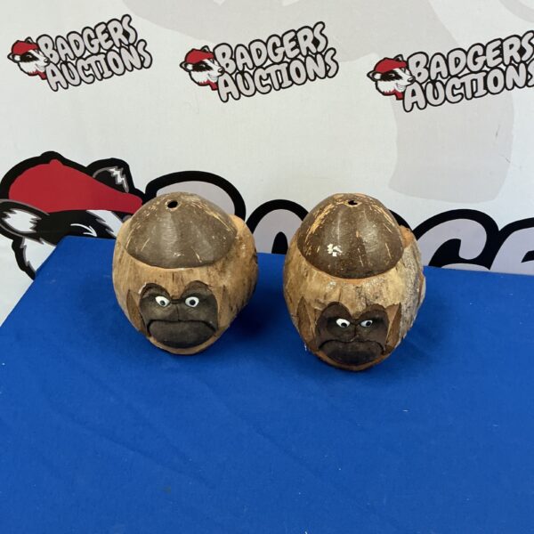 Hand-carved coconut drinking vessels with unique tiki-style faces.