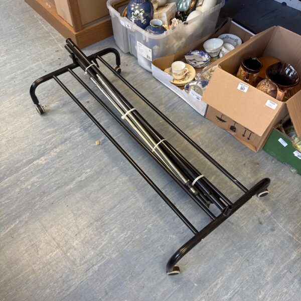 Collapsible metal clothes horse for drying laundry indoors.