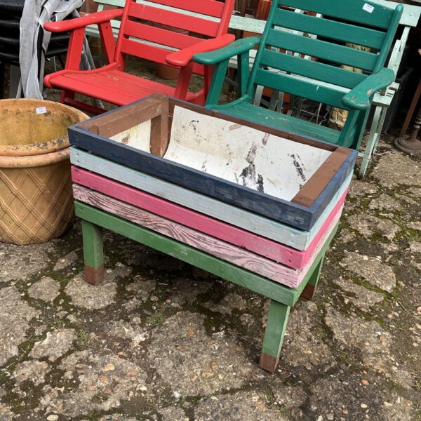 Colourful raised flower planter made from reclaimed wood.
