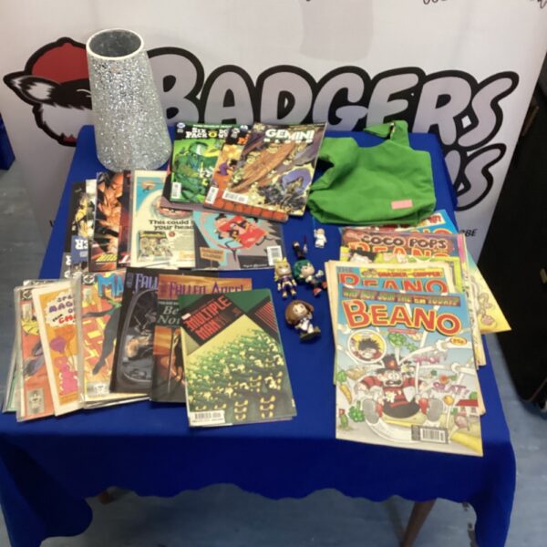 Mixed comic book and toy lot in a pink box.