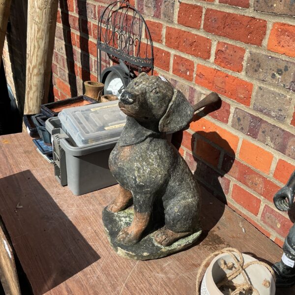 Detailed concrete dog garden ornament for outdoor display.