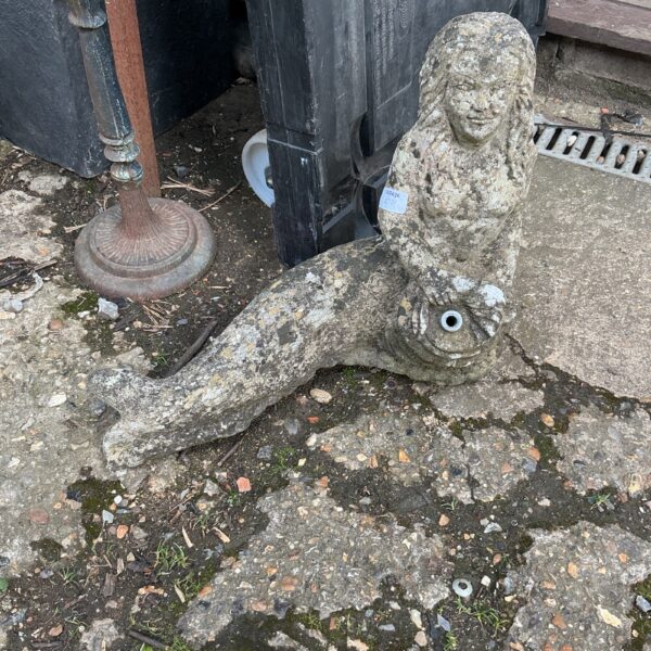 Vintage concrete mermaid garden figurine with weathered patina.