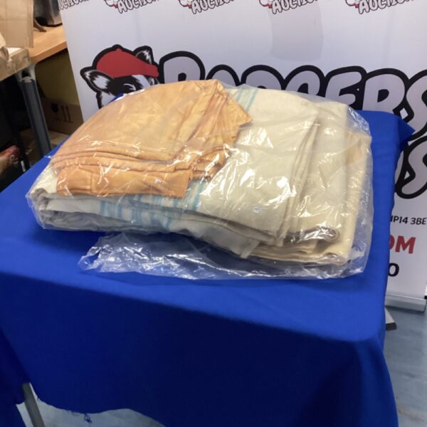 Two large cream blankets displayed on a blue background.