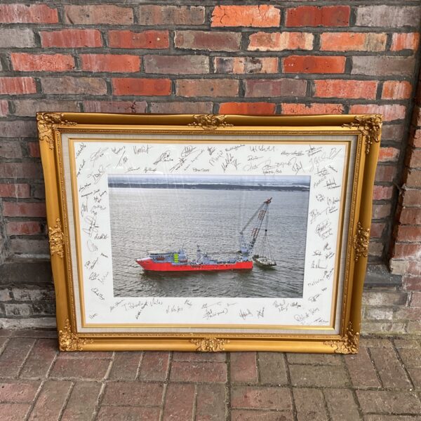 Large gilt-framed crew signed coastline crane ship photograph.