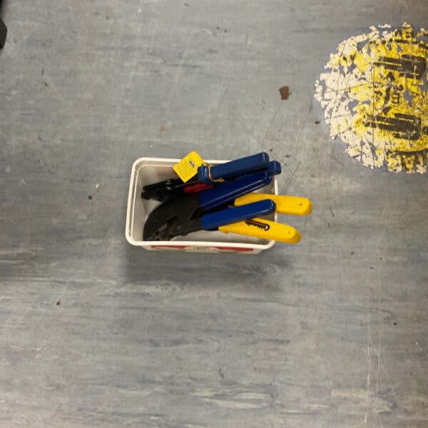 Assortment of crimp tools for cable termination and stripping.