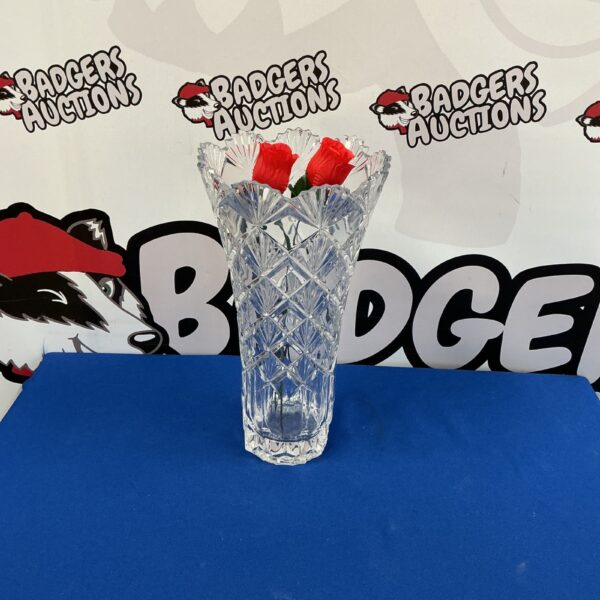 Tall crystal vase with intricate cut glass design.