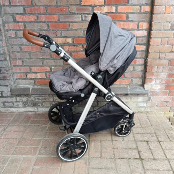 Grey Cuggl pushchair with adjustable canopy and black frame.