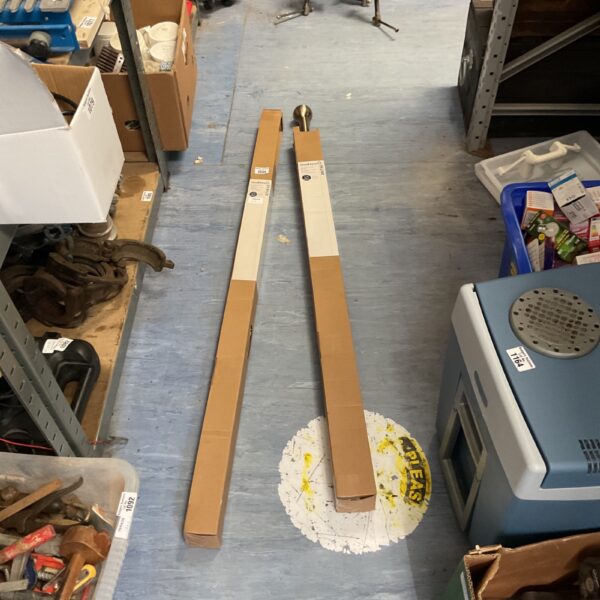Metal curtain pole set sections for window treatment.