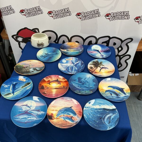 Collection of Danbury Mint dolphin plates for collectors.