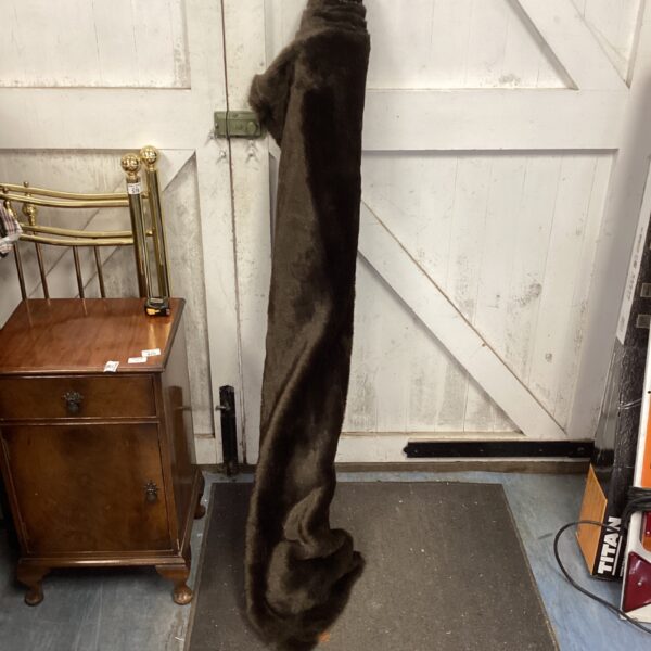 Dark faux fur upholstery fabric roll for home decor projects.