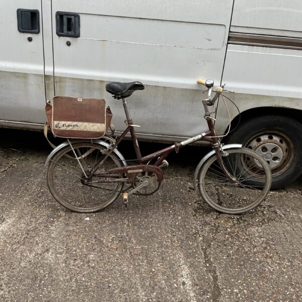 Vintage Dawes Kingpin folding bicycle with front luggage carrier.