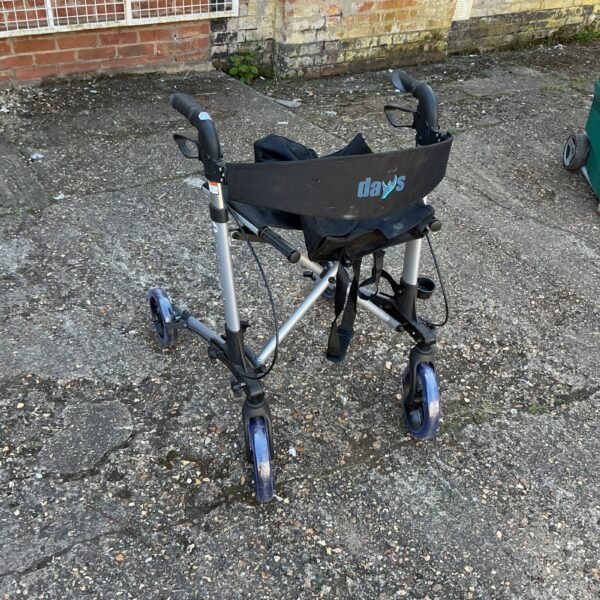 Days walking aid trolley with wire basket and adjustable handlebars.