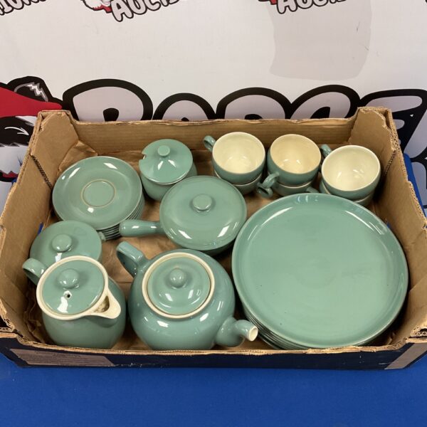 Vintage Denby stoneware service set with tea and coffee pots on display.