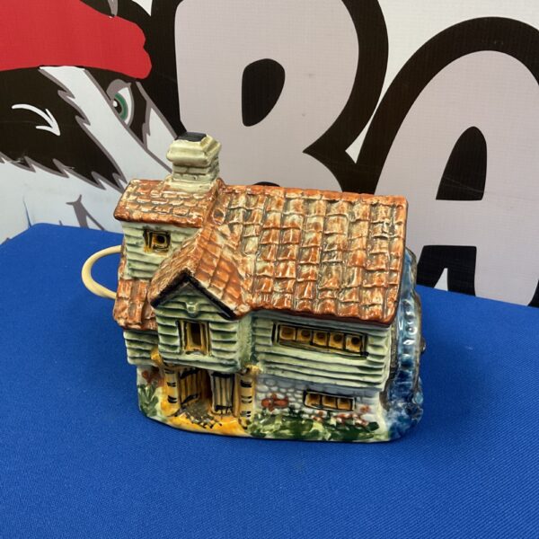 Vintage Derek Fowler pottery cottage table lamp with detailed ceramic design.