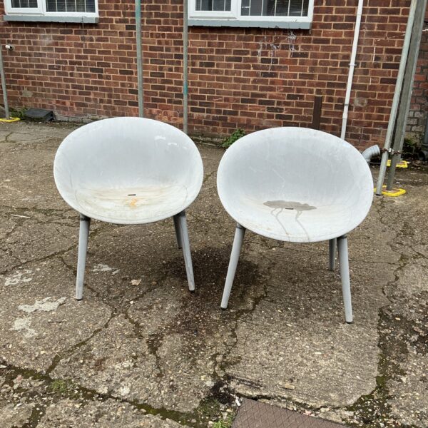 Pair of retro designer garden chairs with faded plastic.