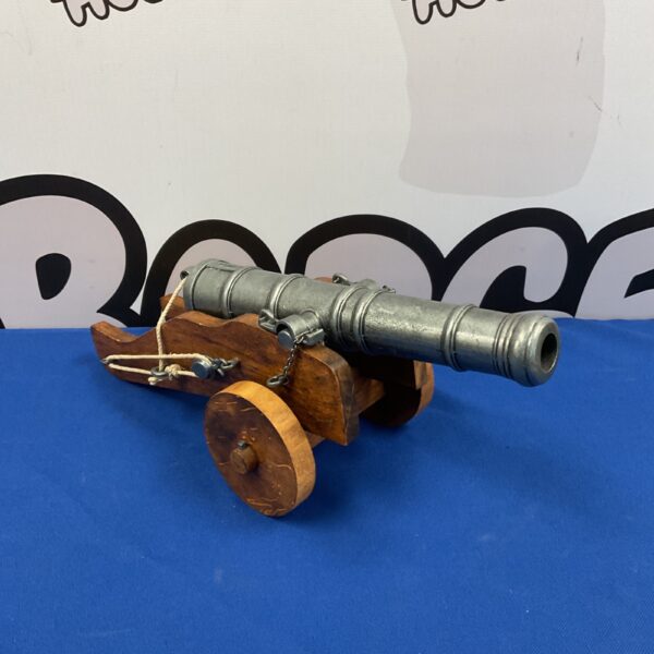 Side view of a decorative desktop cannon model.