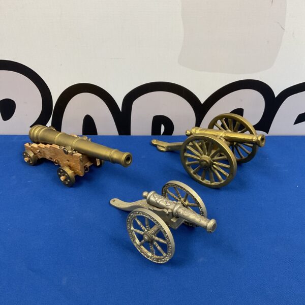 Antique brass and silver plate desktop model cannons for collectors.