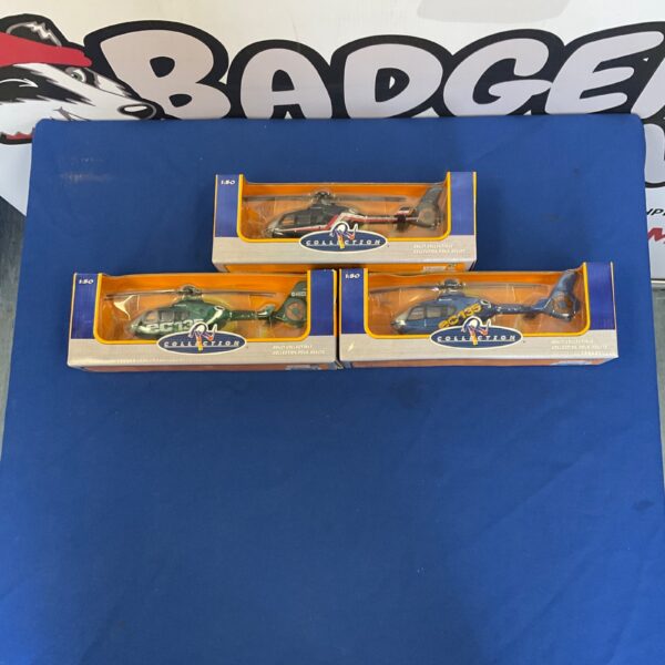 Detailed diecast model helicopters in clear display cases, aviation collectibles.