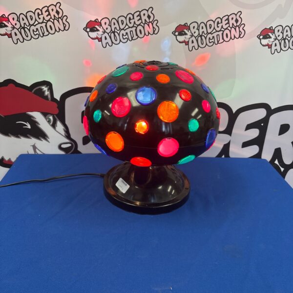 Rotating disco ball light for parties and retro decor.