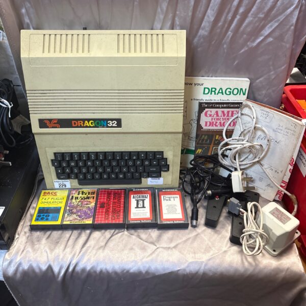 Vintage Dragon 32 home computer with games and joysticks.