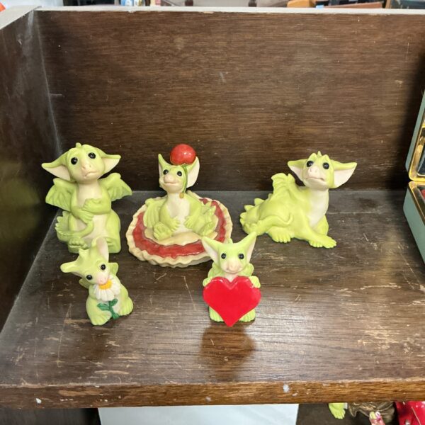 Close-up of a lot of whimsical dragon figurines.