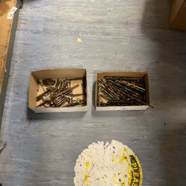 Assorted vintage drill bits in a cardboard box.