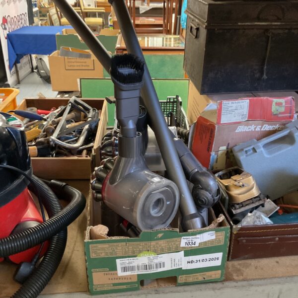 Dyson cordless vacuum cleaner with various cleaning attachments.
