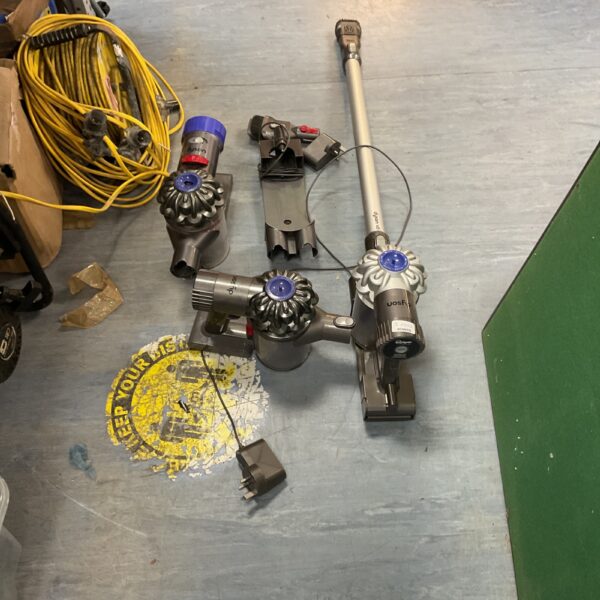 Dyson V8 cordless vacuum cleaner with various attachments for cleaning.