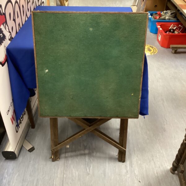 Vintage early 1900s folding card table with green felt top.