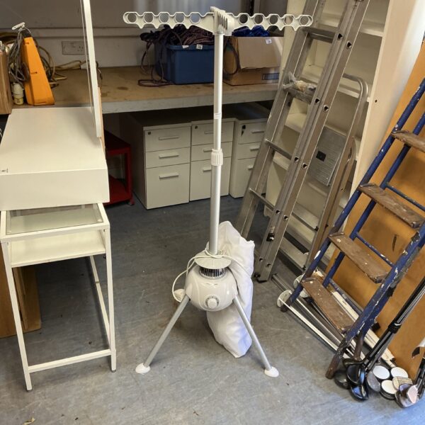 Used electric rotary clothes airer for indoor laundry.