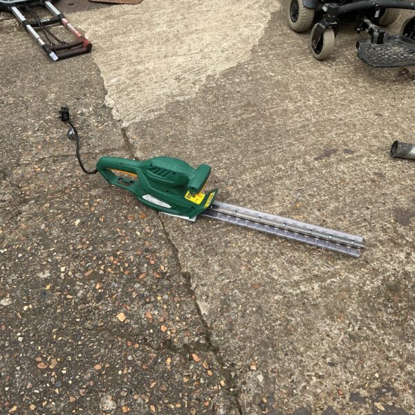 Used electric hedge trimmer for garden landscaping and maintenance.