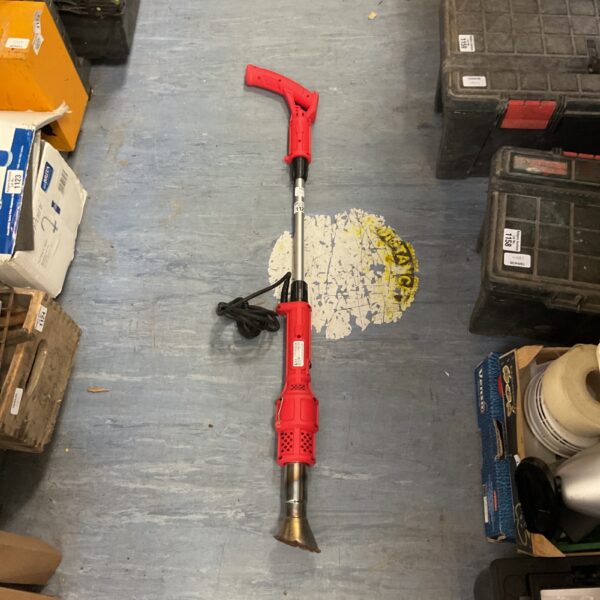 Electric weed burner with long handle for garden weed control.