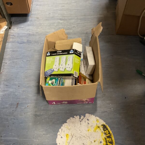 Assorted electrical sockets and lightbulbs in a cardboard box.