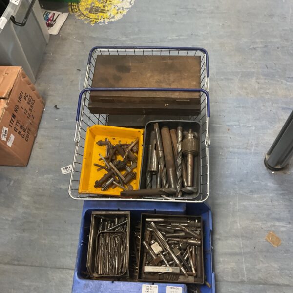 Assorted engineering tool accessories in a plastic container.