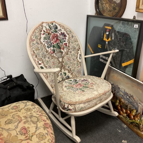 Vintage Ercol rocking chair with floral upholstery and beech wood frame.