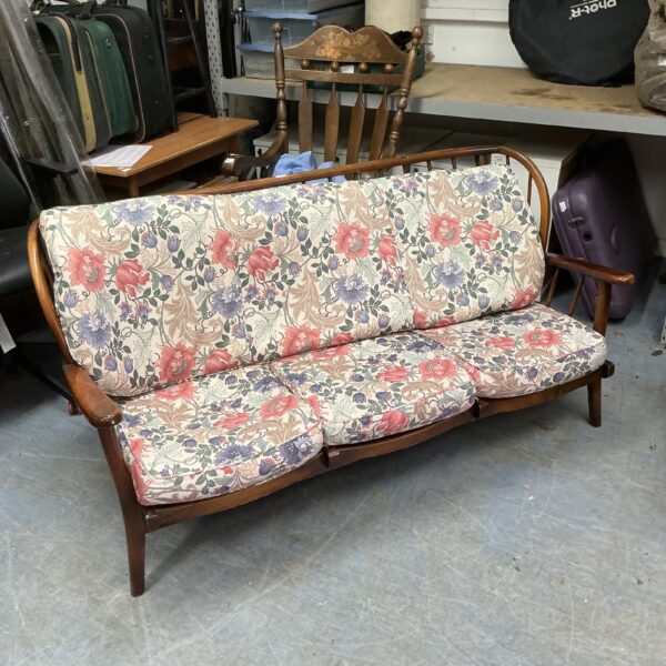 Vintage Ercol three-seater sofa with patterned upholstery and beechwood frame.