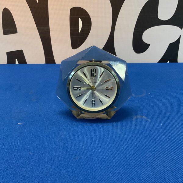 Vintage Estyma desk clock with a square case and simple dial.