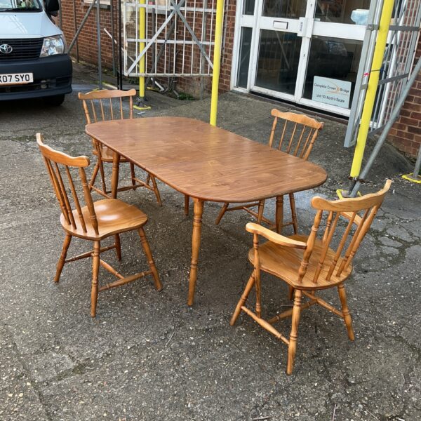 Vintage farmhouse extending dining table and four chairs.