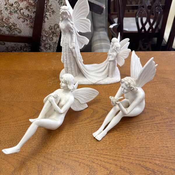 Vintage fairy shelf ornaments with a delicate bridge.
