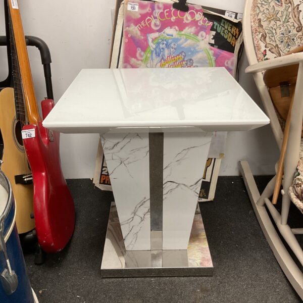 Vintage faux marble pedestal table with silver base.