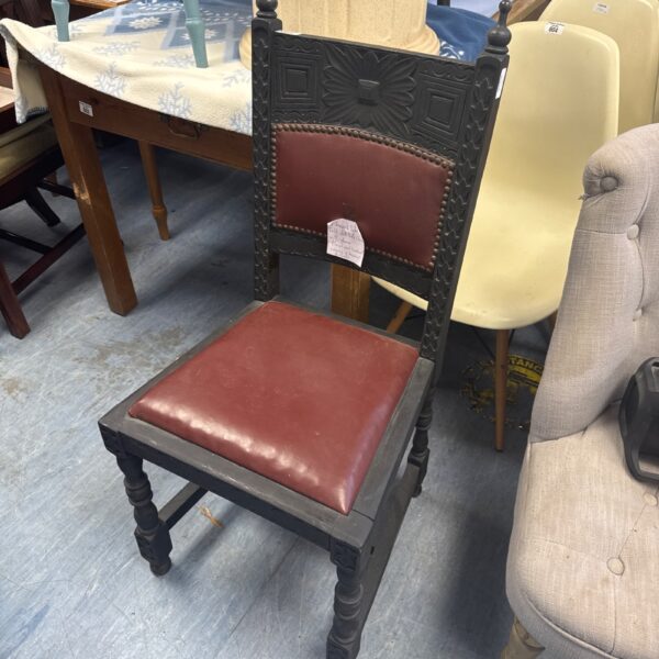 Vintage Finnish folk art chair with detailed carvings.