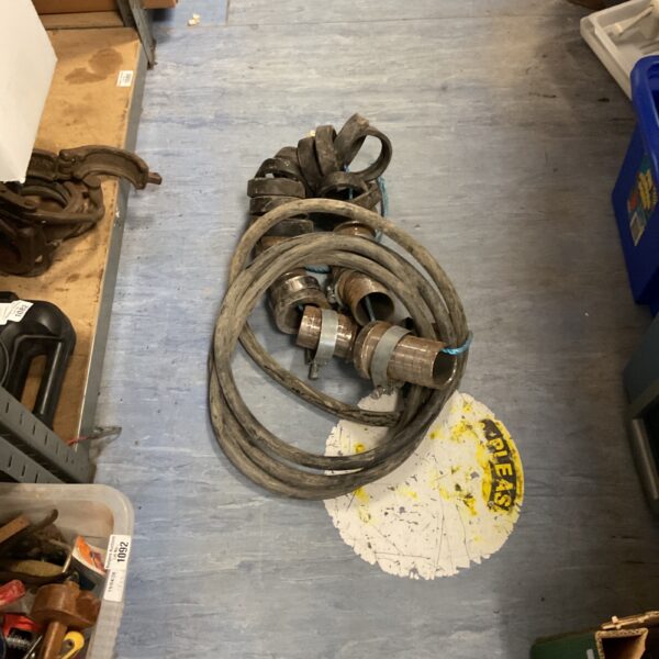 Vintage fire hose assembly with nozzle and fittings.