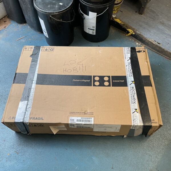 Fisher Paykel LPG hob in original packaging, showing wear.