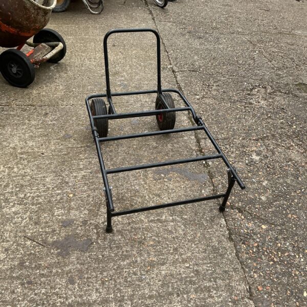 Folding fishing tackle trolley with two wheels for easy transport.