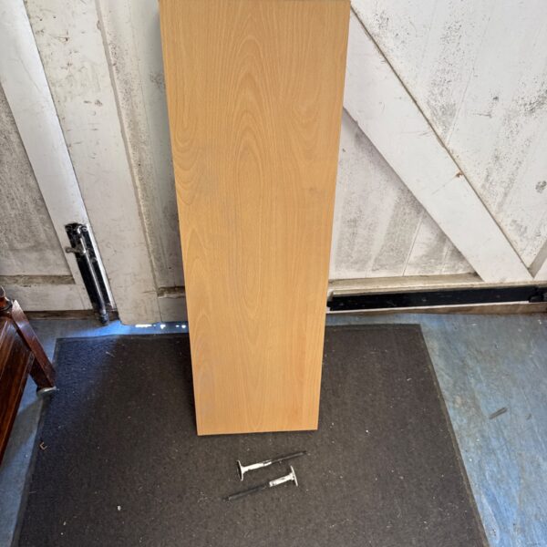 Pine effect floating shelf on a dark surface, ready for mounting.