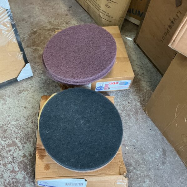 Two boxes of floor scrubbing pads for commercial cleaning.
