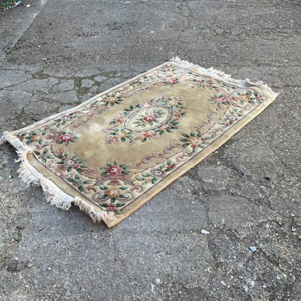 Detailed floral pattern on a large vintage rug.