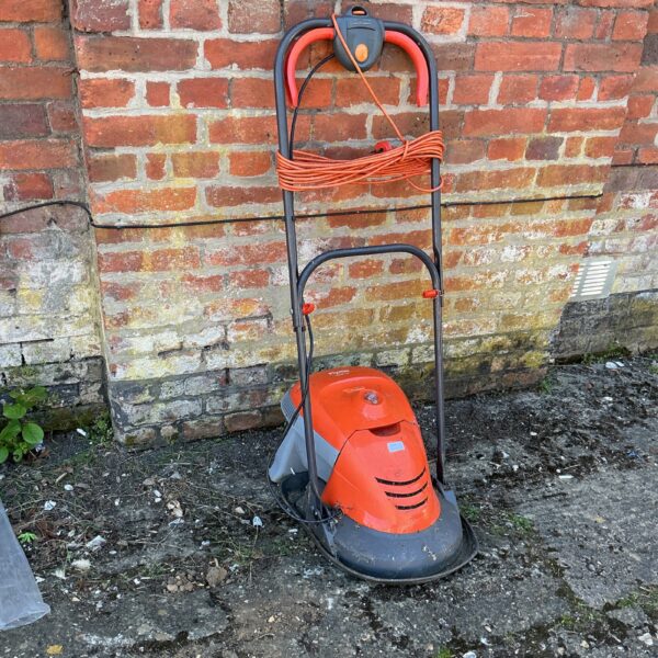 Vintage Flymo electric lawn mower for garden maintenance.