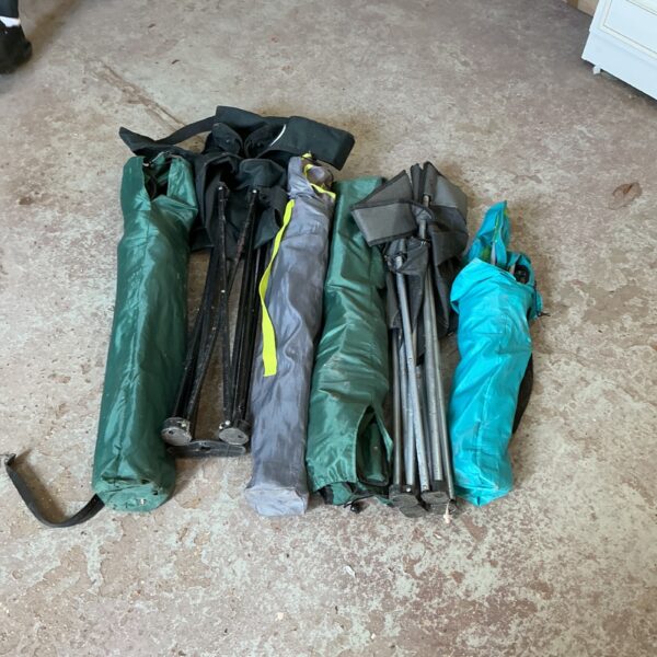 Lot of folding camping chairs for outdoor use.