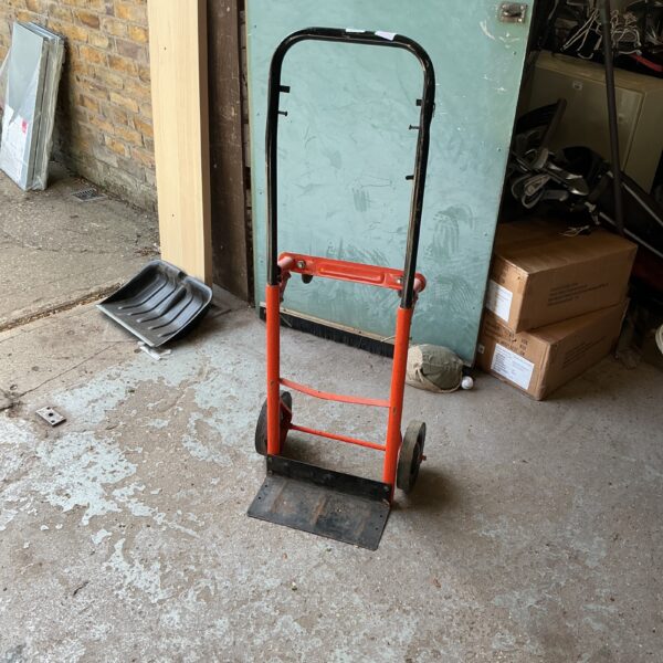 Red and black folding multi-purpose trolley for light transport.